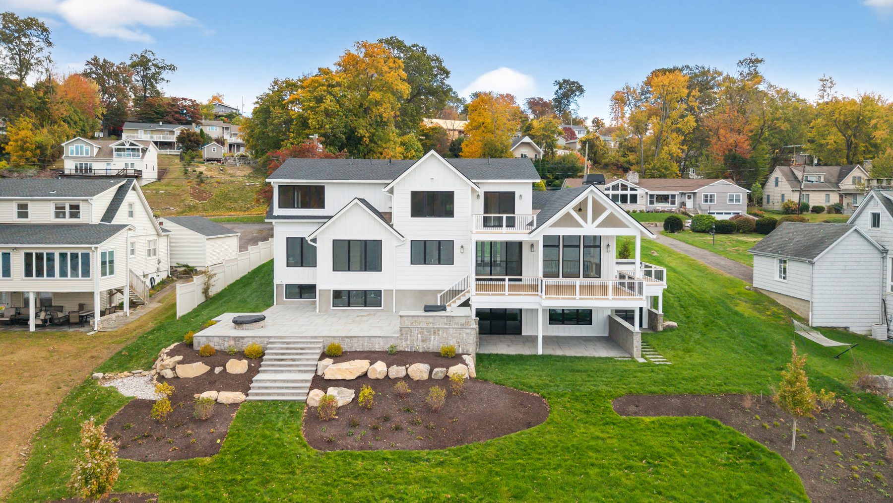 Aerial of the lakeside home and its driveway nestled into the wooded Candlewood Shores neighborhood - 148 North Lake Shore on Candlewood Lake