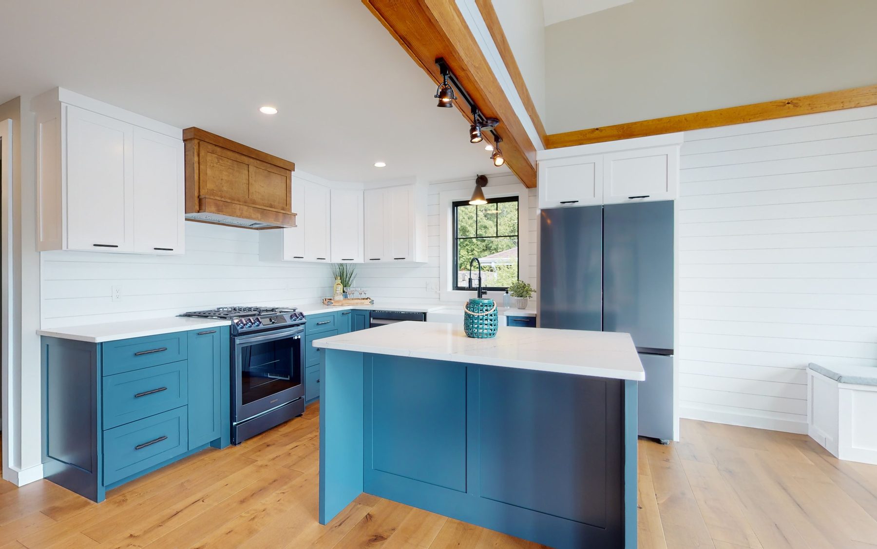 Vaulted loft with an exposed beam, ceiling fan and a trio of windows opening to the lake beyond the cable railing — 3 Woods Road, a custom lakefront home in Candlewood Knolls on Candlewood Lake