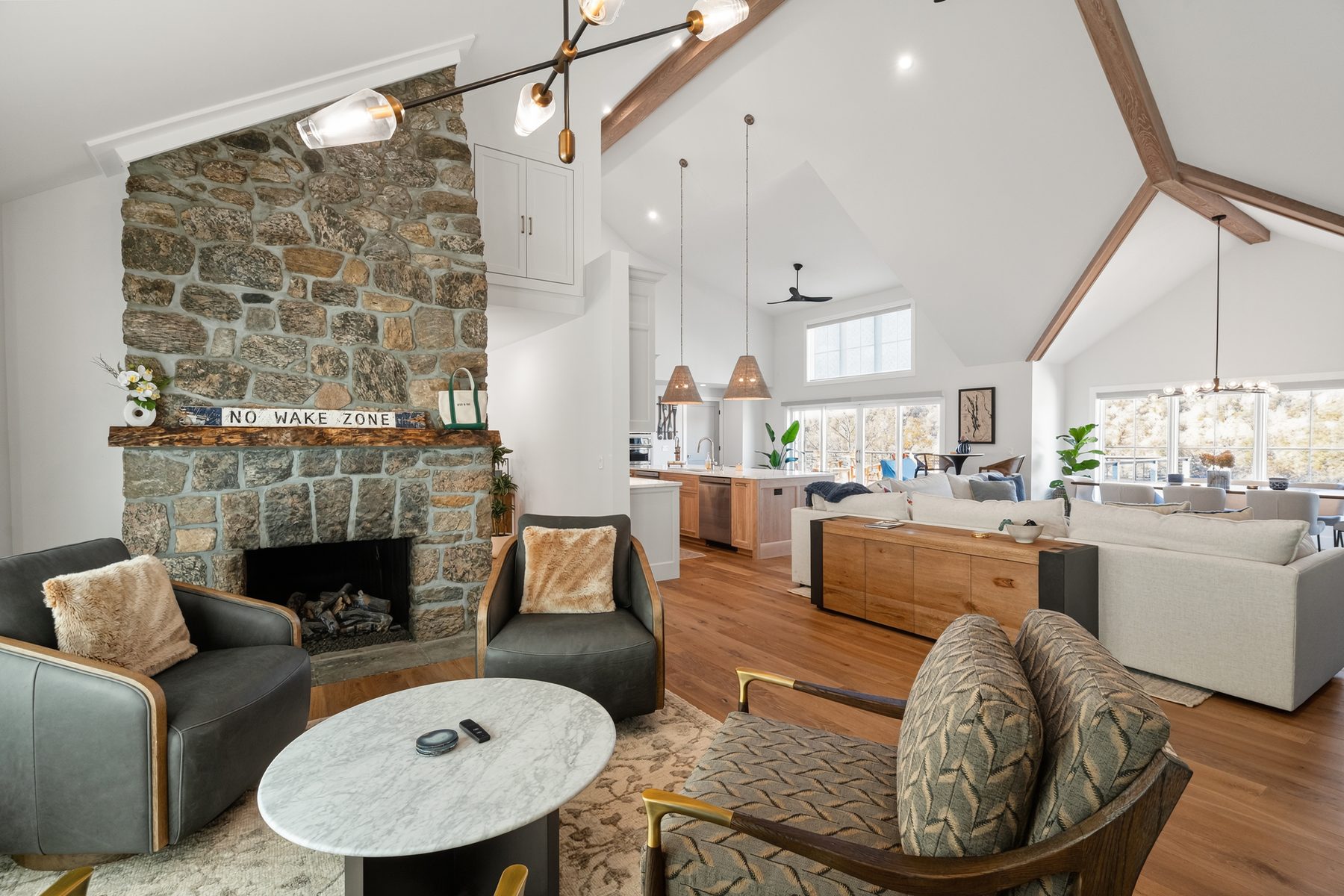 Living area anchored by a floor-to-ceiling stacked-stone fireplace beneath vaulted beamed ceilings - 43 Moody Lane, a custom home in Danbury, CT